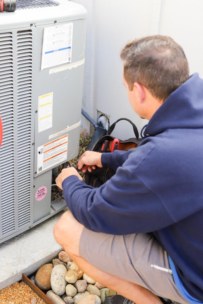 AC & Heat Solutions technician performaing an AC tuneup in Grapevine