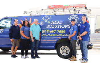 Photo of the team at AC & Heat Solutions standing with their iconic van