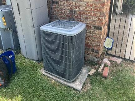 Our technician working on an AC condenser unit – AC & Heat Solutions offers the best AC installations in Northeast Tarrant County.